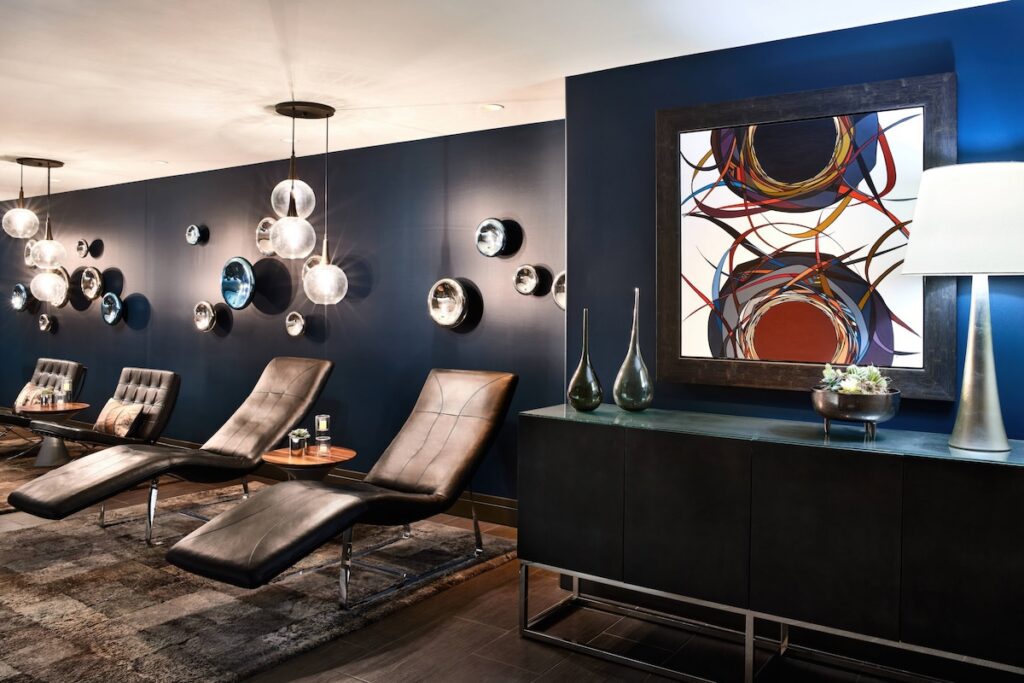 Spa relaxation lounge with leather chaise longues and globe lighting at ADERO Scottsdale