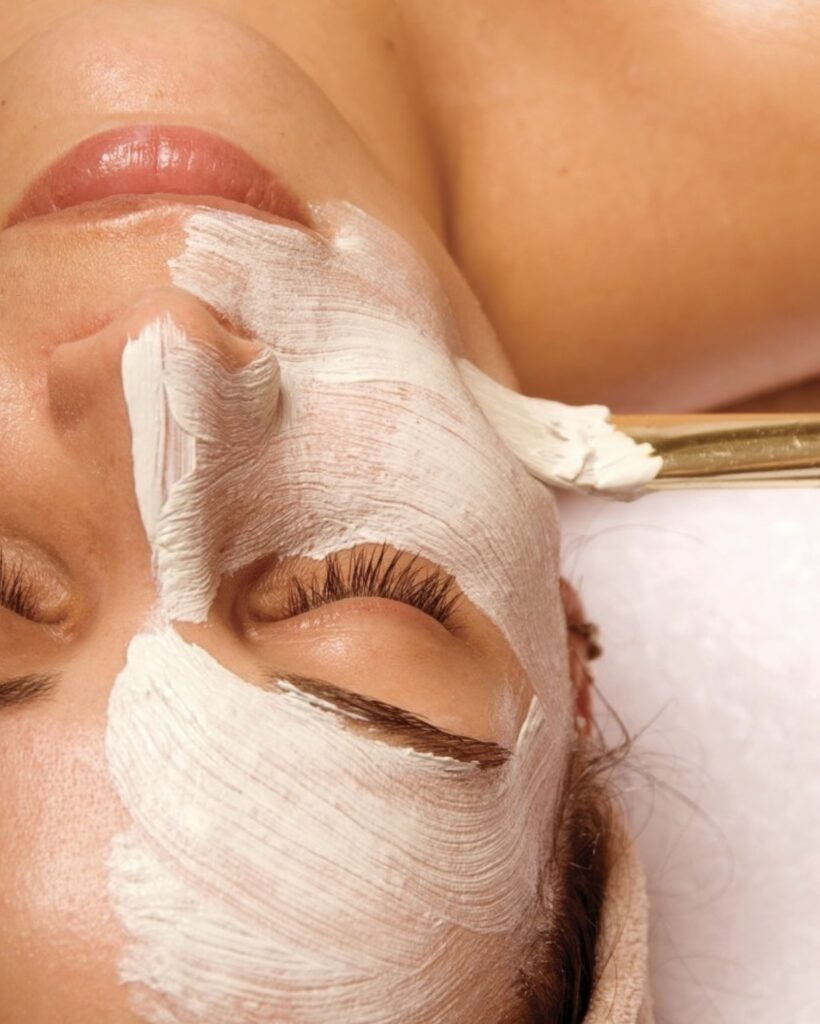 White clay mask being applied by brush to woman's face during facial at Arizona Grand Resort & Spa, Phoenix