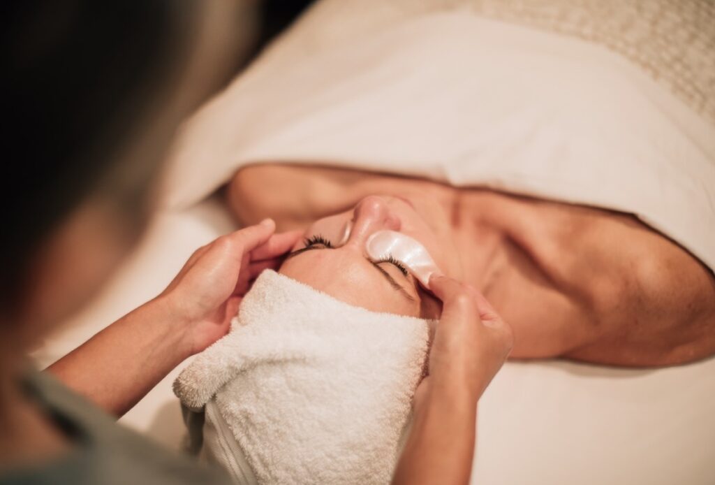 Therapist applying cream during a facial treatment at the spa at Four Seasons Resort Scottsdale
