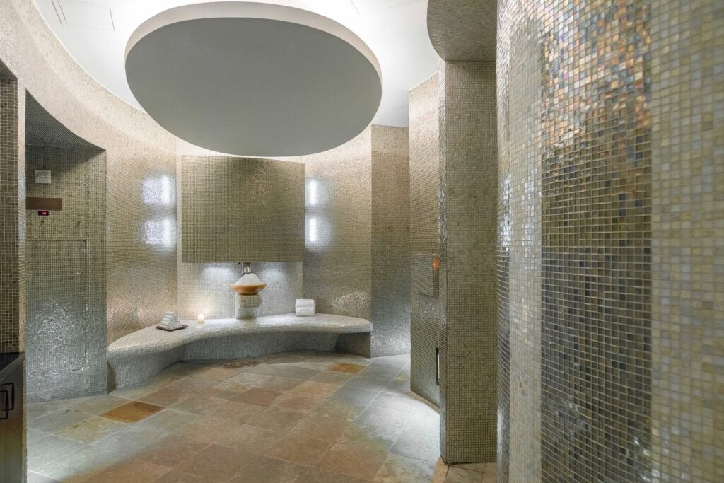 Spa hammam with iridescent silver mosaic curved walls and circular ceiling detail at Acqualina Resort & Residences, Sunny Isles Beach