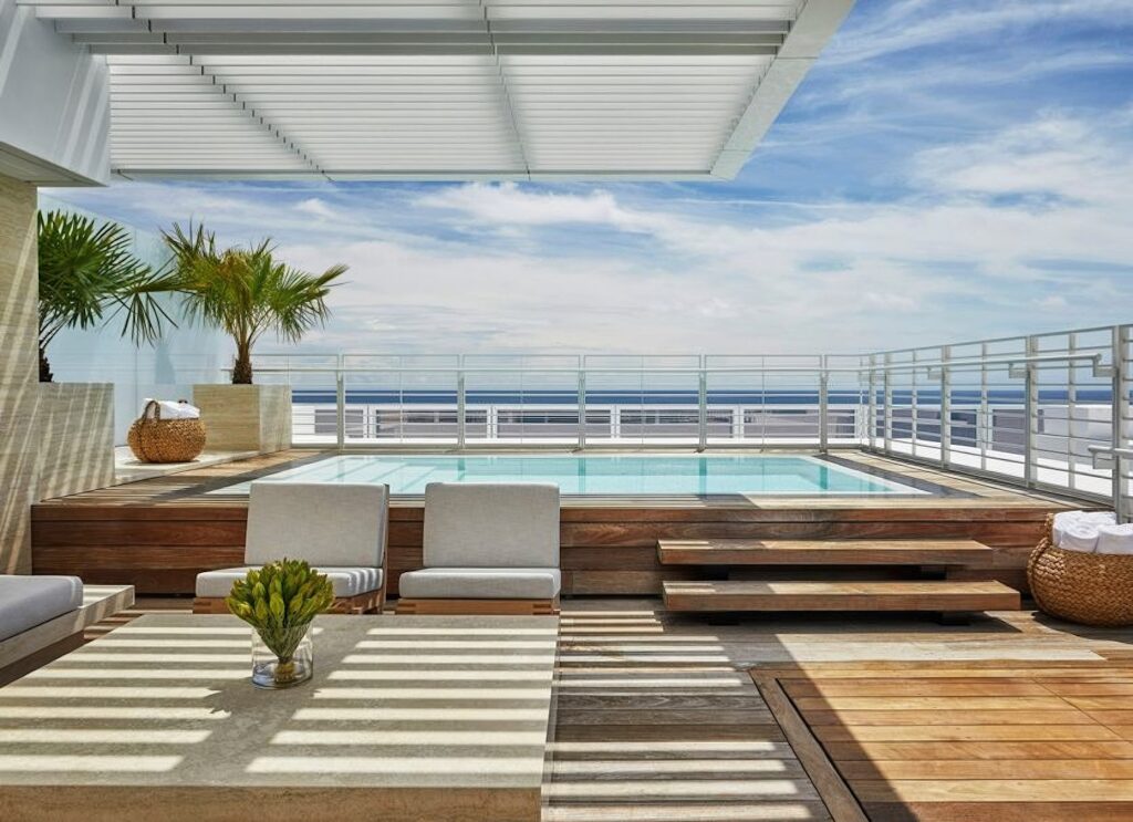Private rooftop plunge pool on teak deck with ocean views and white pergola at Four Seasons Hotel at The Surf Club, Surfside