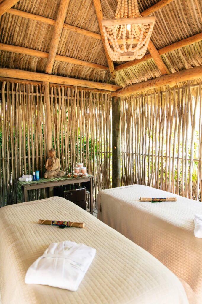 Double treatment room inside open-air bamboo tiki hut with beaded chandelier and Buddha statue, The Palms Hotel & Spa, Miami Beach