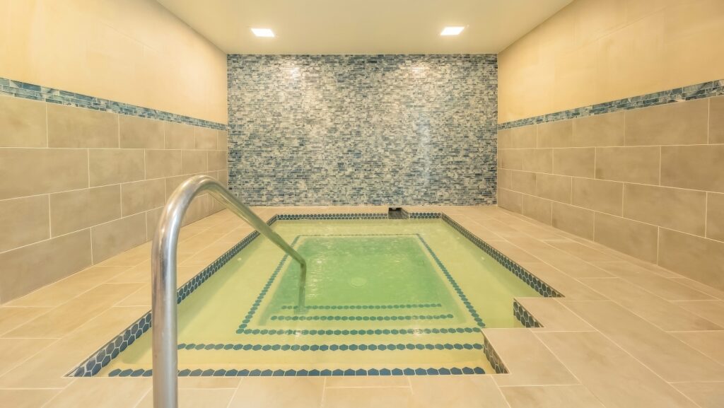Indoor hydrotherapy pool with blue mosaic accent wall at Ventana Canyon Club and Lodge, Tucson