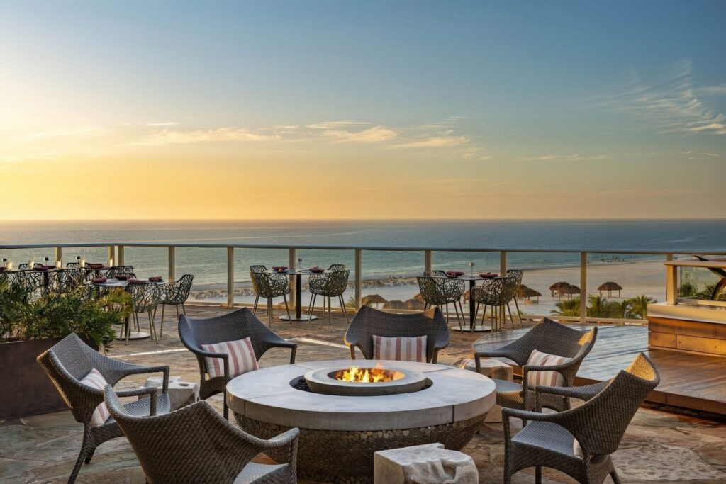 Rooftop terrace fire pit with wicker seating and panoramic Gulf sunset at JW Marriott Marco Island Beach Resort, Marco Island Florida
