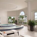 Spa whirlpool with blue diamond tile surround and tall arched windows at The Ritz-Carlton, Naples, Naples Florida