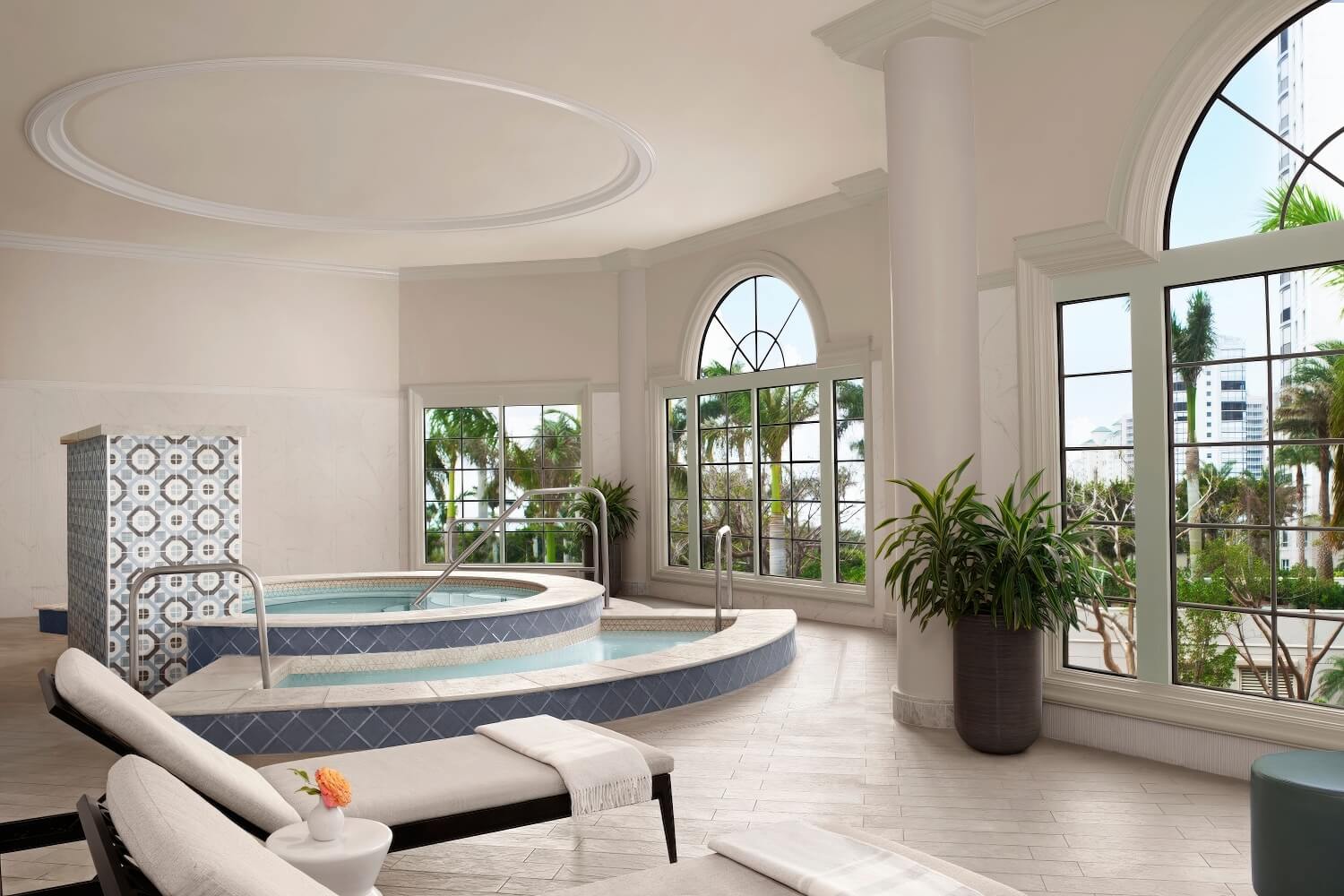 Spa whirlpool with blue diamond tile surround and tall arched windows at The Ritz-Carlton, Naples, Naples Florida