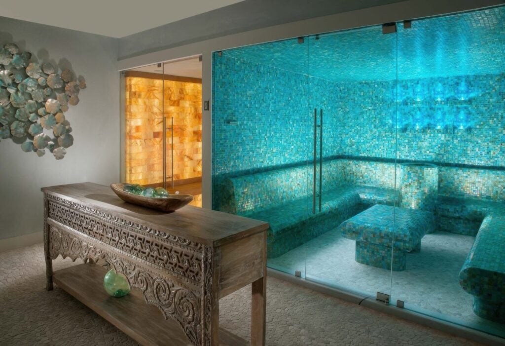 Spa steam room with turquoise mosaic tile and adjacent salt sauna at Bungalows Key Largo, Florida Keys