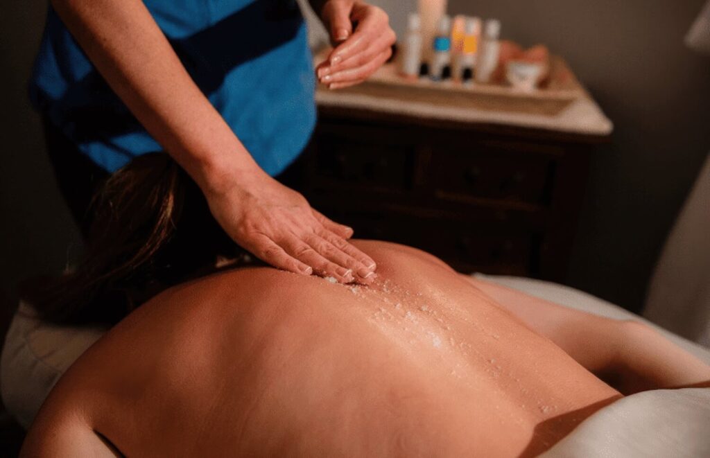 Salt scrub massage treatment being performed in the spa at Hawks Cay Resort, Duck Key Florida