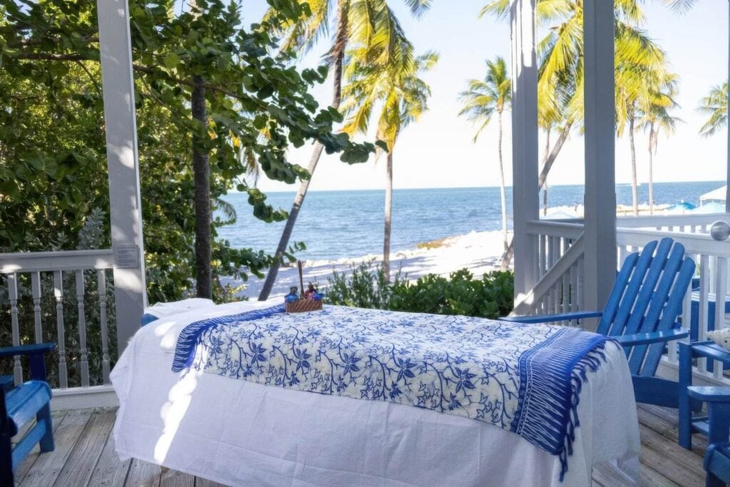 Outdoor massage table on covered porch overlooking the ocean at Tranquility Bay Beachfront Resort, Marathon, Florida Keys