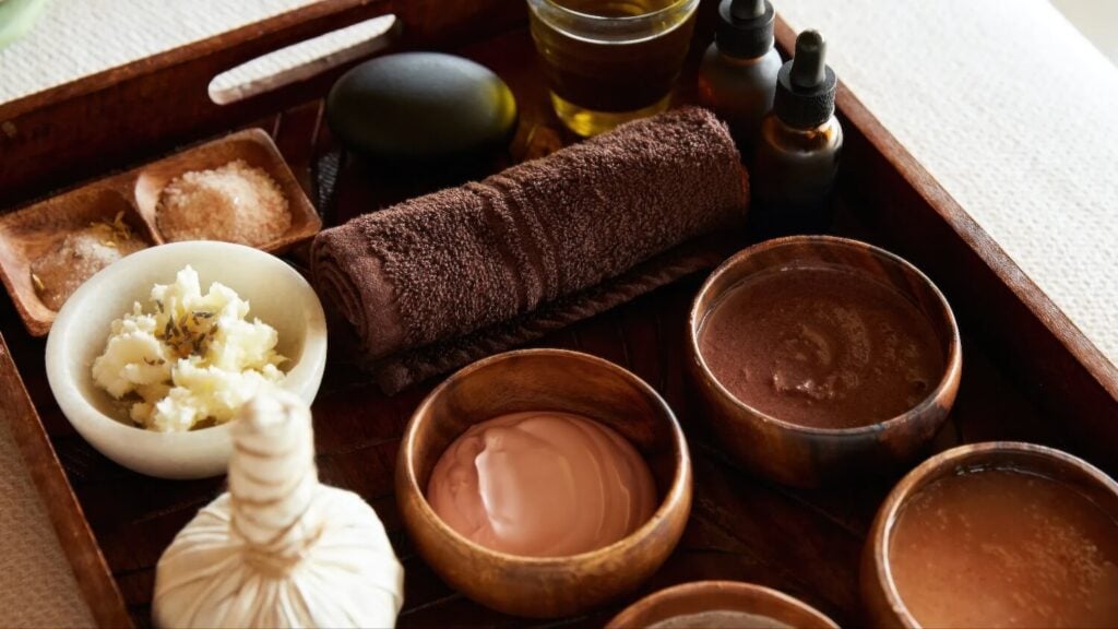 Wooden tray of massage oils, salts, body scrubs and a hot stone at the spa, Auberge du Soleil, Rutherford, Napa Valley
