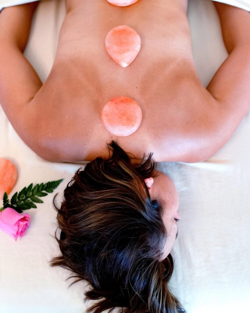 Himalayan pink-salt stones placed along a guest's back during a massage at Calistoga Motor Lodge & Spa, Calistoga