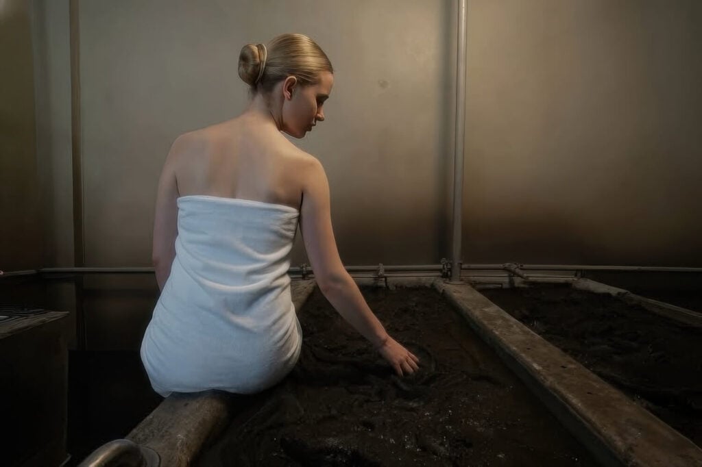 Guest in a towel beside the signature volcanic-ash mud bath, Indian Springs Resort, Calistoga, California