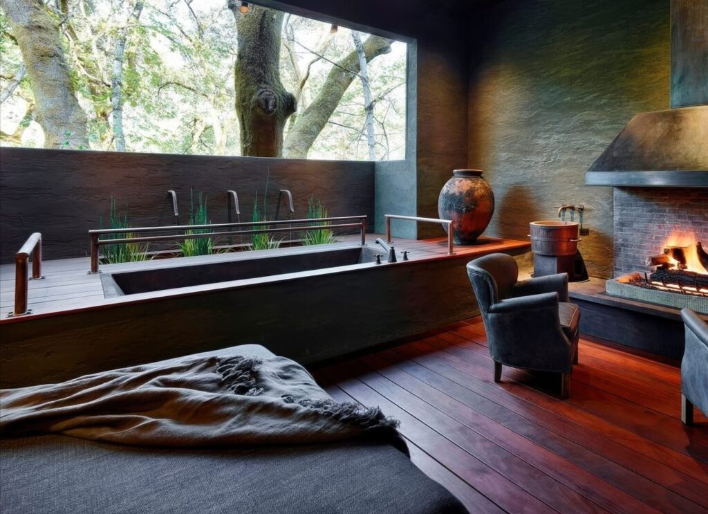 Spa suite with concrete soaking tub, fireplace and forest-view window at Meadowood Napa Valley, St. Helena, California
