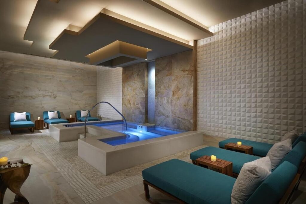 Spa hydrotherapy lounge with plunge pool and teal loungers at Seminole Hard Rock Tampa, Florida
