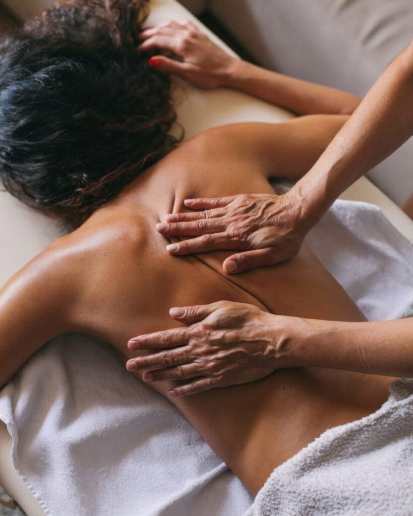 Therapist giving a back massage to a guest on a spa table at Silverado Resort and Spa, Napa