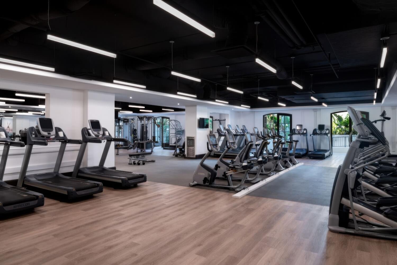Fitness centre with treadmills, bikes and weights under black industrial ceilings at The Ritz-Carlton Bacara, Santa Barbara