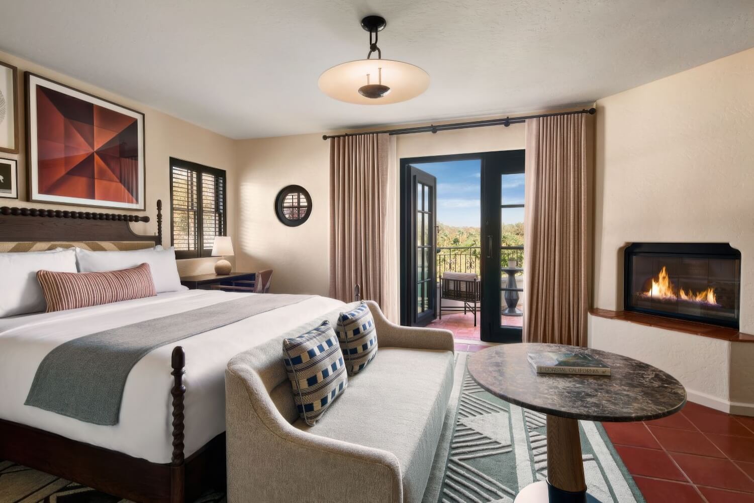 King guest room with a gas fireplace, coastal decor and a private balcony at The Ritz-Carlton Bacara, Santa Barbara