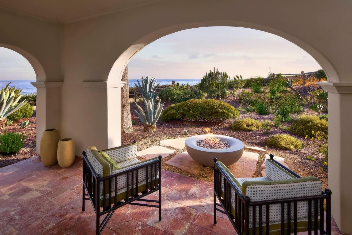 Private arched patio with a fire bowl overlooking the agave garden and ocean at dusk, The Ritz-Carlton Bacara, Santa Barbara