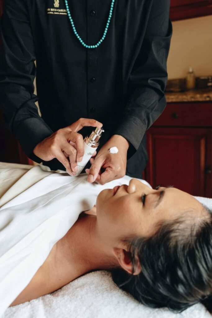Therapist applying serum during a facial in a treatment room at The Ritz-Carlton Bacara, Santa Barbara