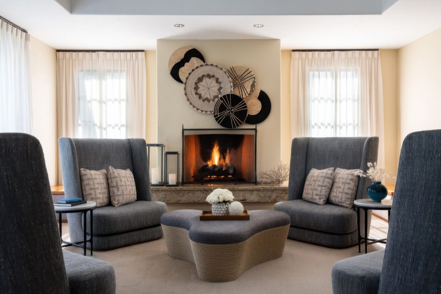 Spa fireside relaxation lounge with high-back chairs and woven basket art at The Ritz-Carlton Bacara, Santa Barbara