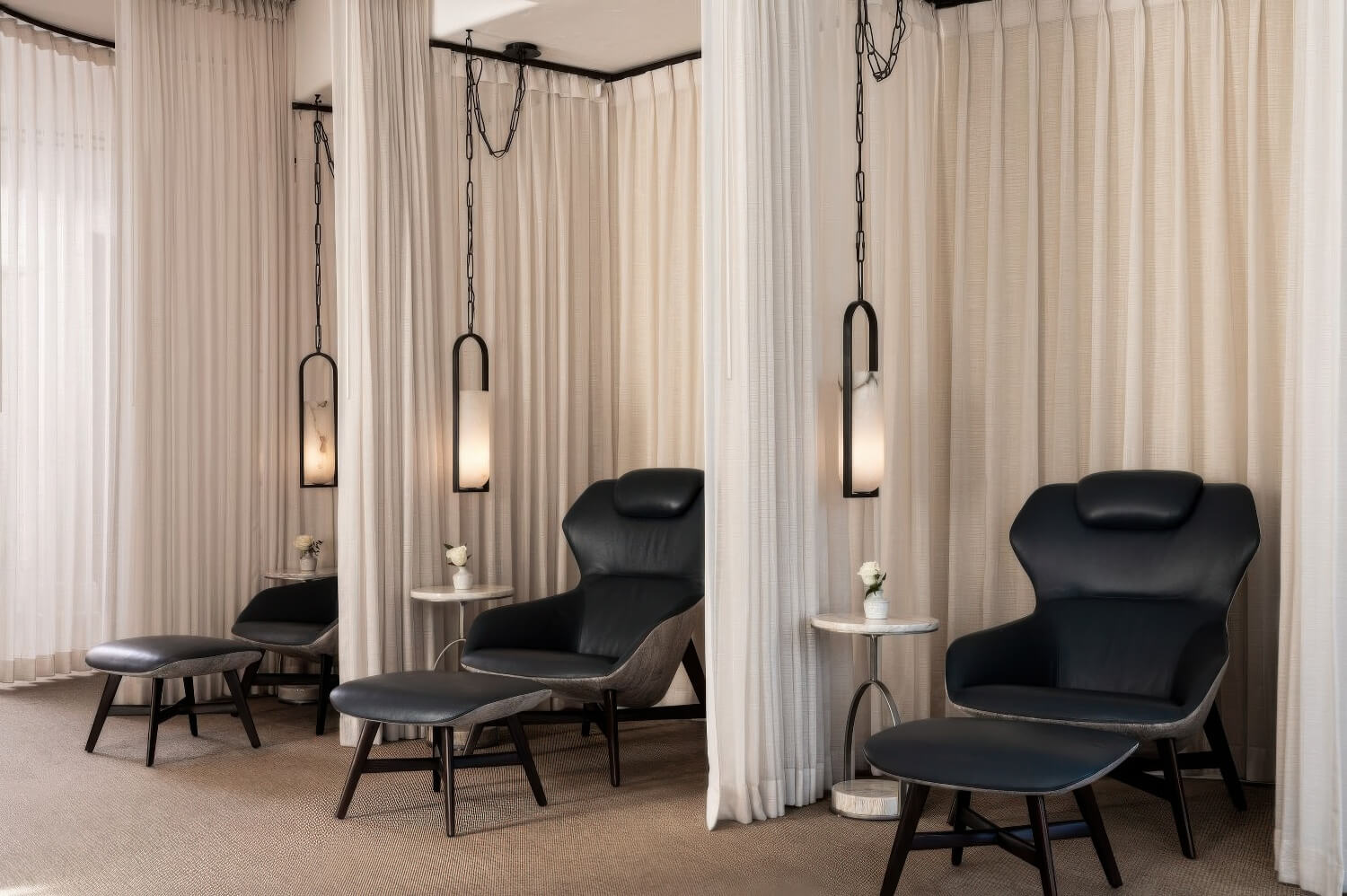 Spa quiet room with black leather lounge chairs and alabaster pendant lights at The Ritz-Carlton Bacara, Santa Barbara