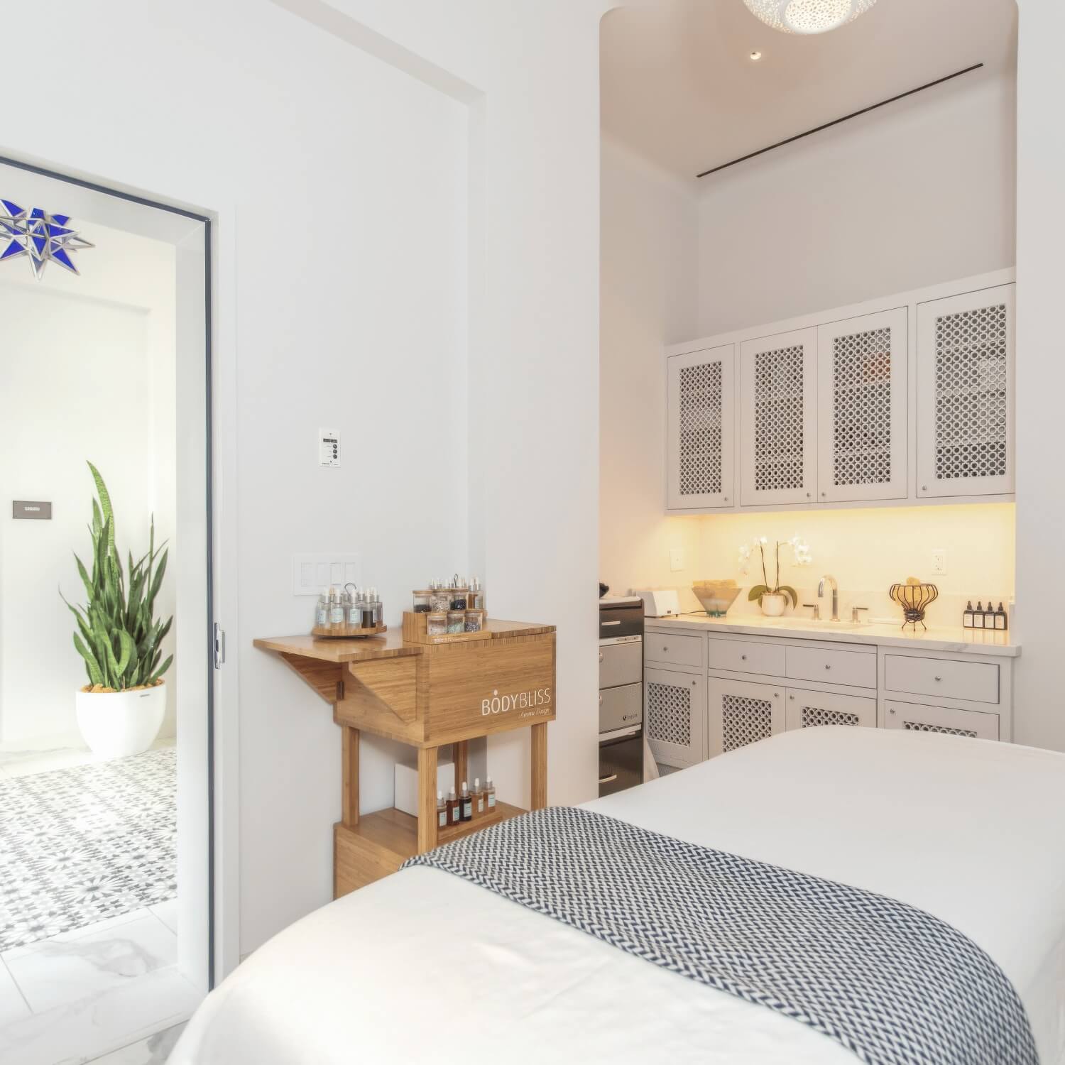 Spa Frescada treatment room with lattice cabinetry and an aromatherapy oil cart at Hotel Californian, Santa Barbara