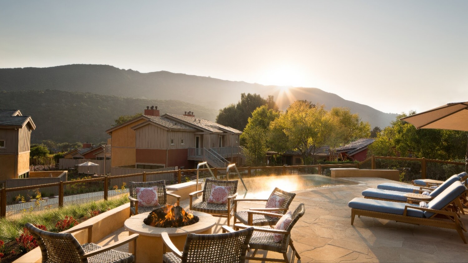 Fire-pit terrace with wicker chairs, steaming whirlpool and sunset over the hills at Bernardus Lodge and Spa, Carmel Valley