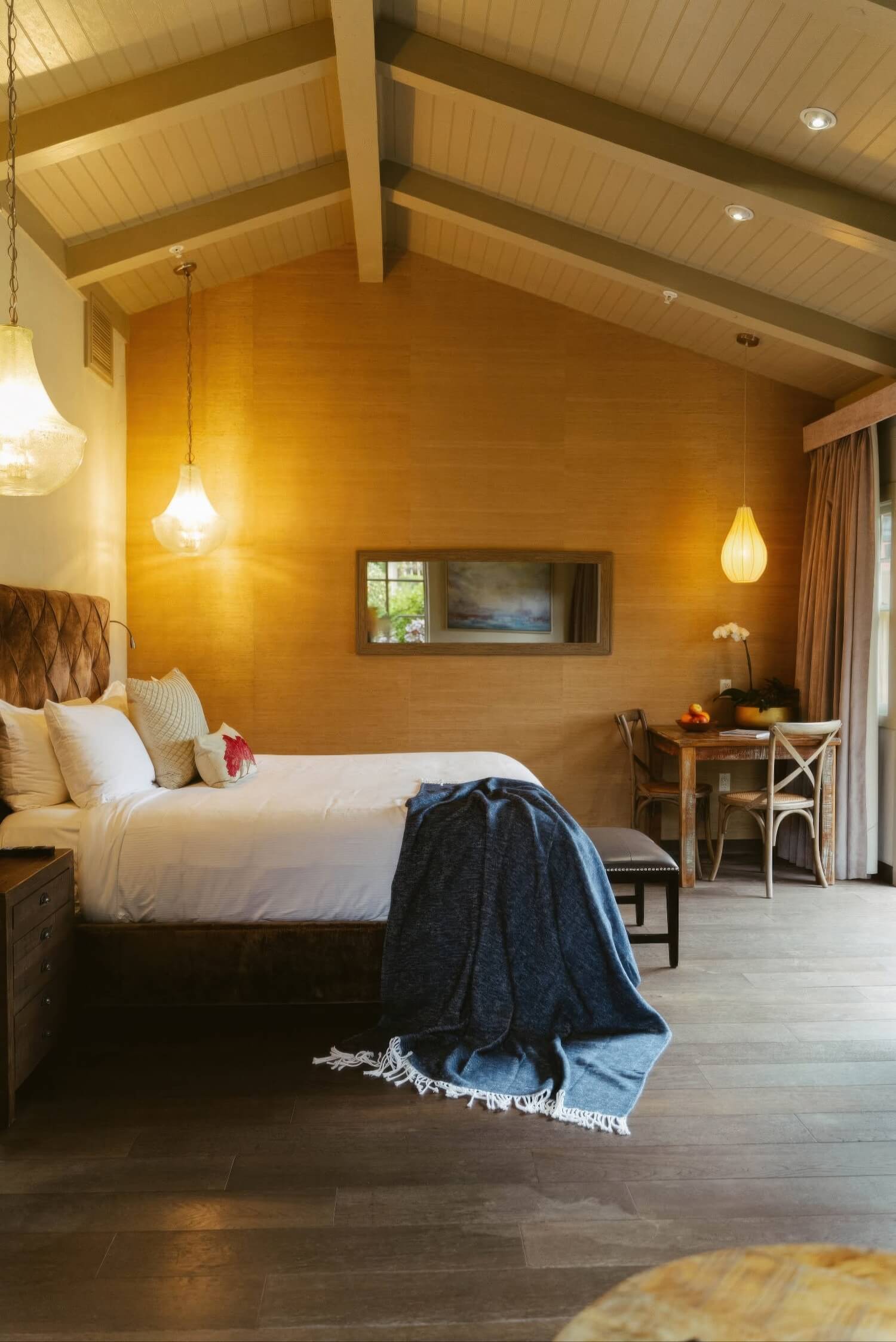 Guest room with vaulted beamed ceiling, grasscloth walls and pendant lamps at Bernardus Lodge and Spa, Carmel Valley