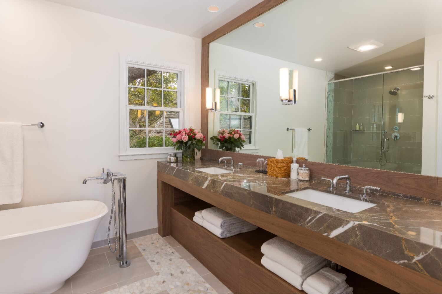 Bathroom with freestanding soaking tub, stone-topped double vanity and glass shower at Carmel Beach Hotel, Carmel-by-the-Sea