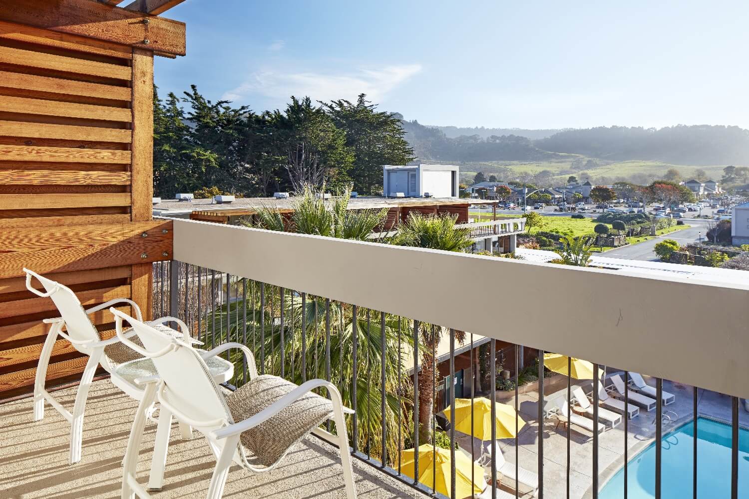 Balcony of a King Superior room at Carmel Mission Inn, Carmel, California, overlooking the pool courtyard and the hills at the mouth of Carmel Valley.