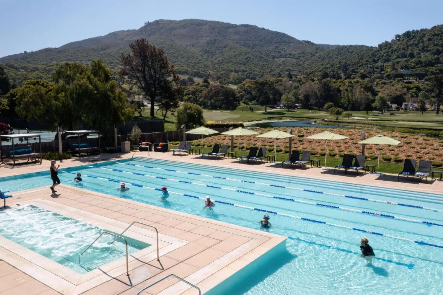 Lane-lined pool with aqua fitness class, lavender beds and Santa Lucia hills at Carmel Valley Ranch, Carmel Valley