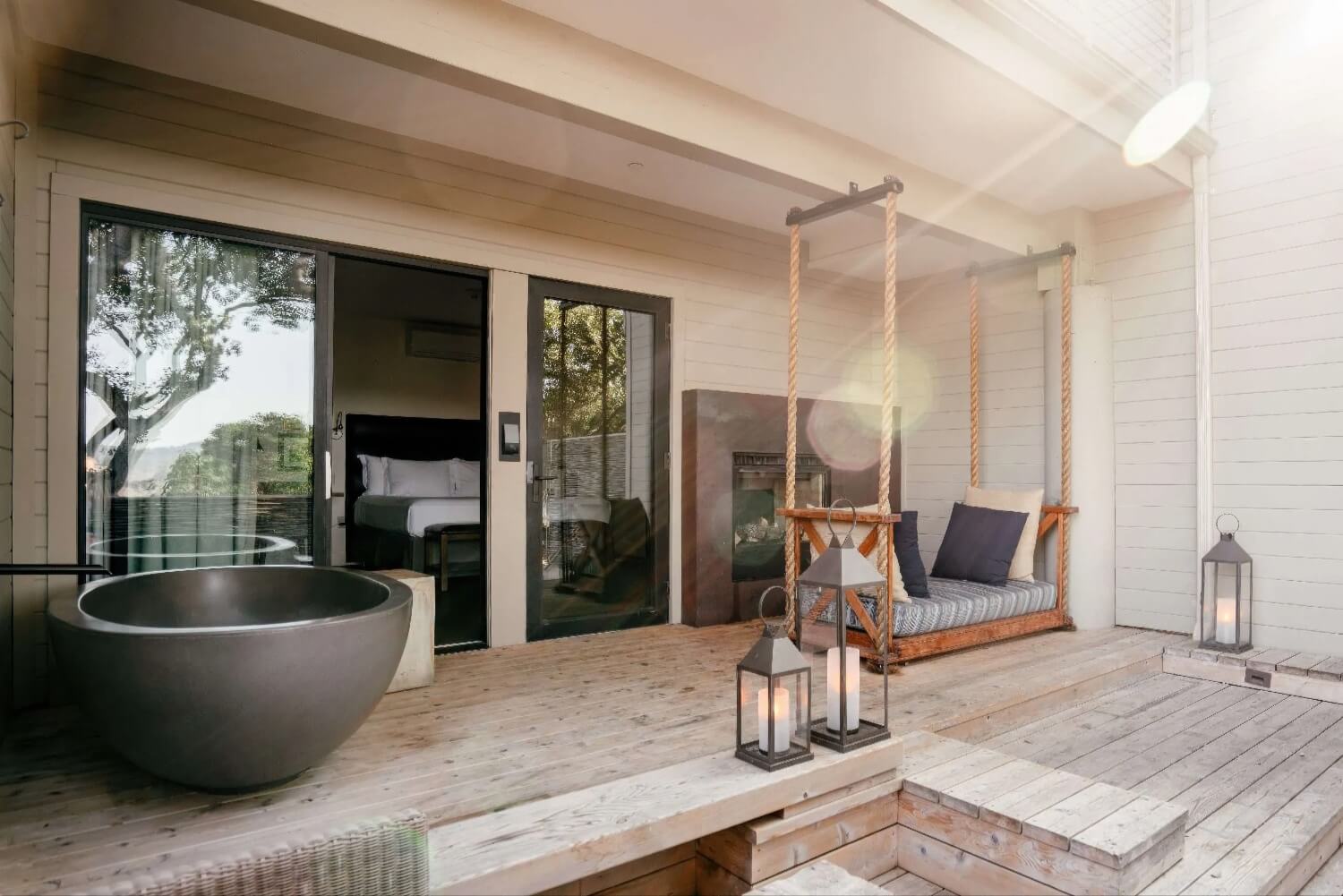 Suite deck with round soaking tub, hanging swing daybed and outdoor fireplace at Carmel Valley Ranch, Carmel Valley