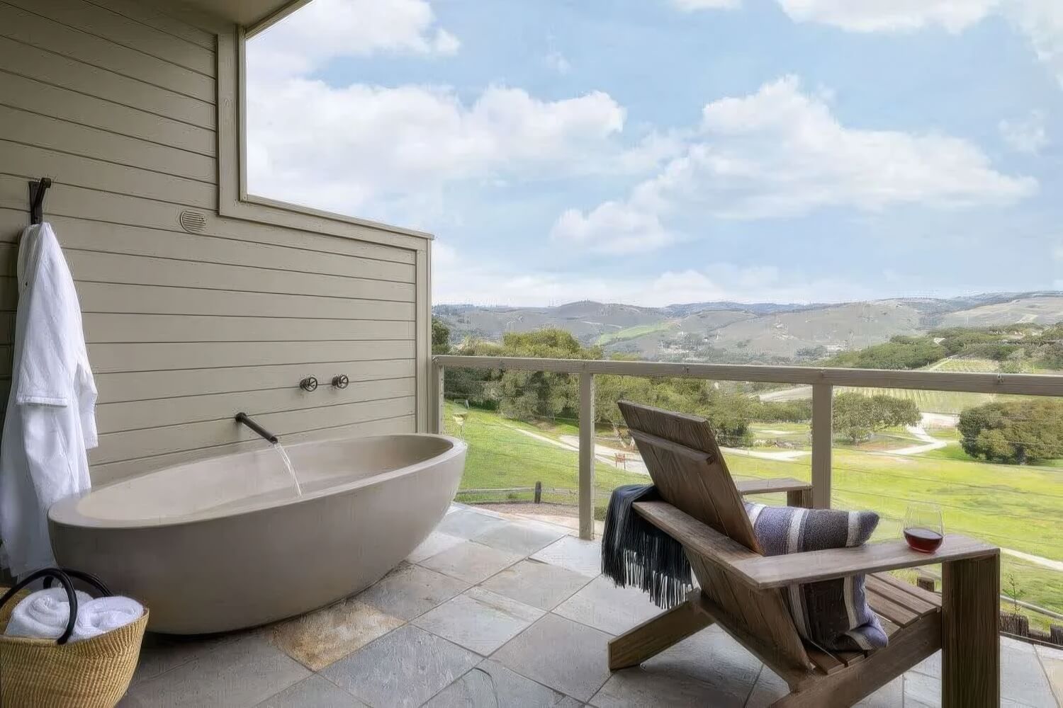 Vineyard Suite balcony with soaking tub and Adirondack chair overlooking the valley at Carmel Valley Ranch, Carmel Valley