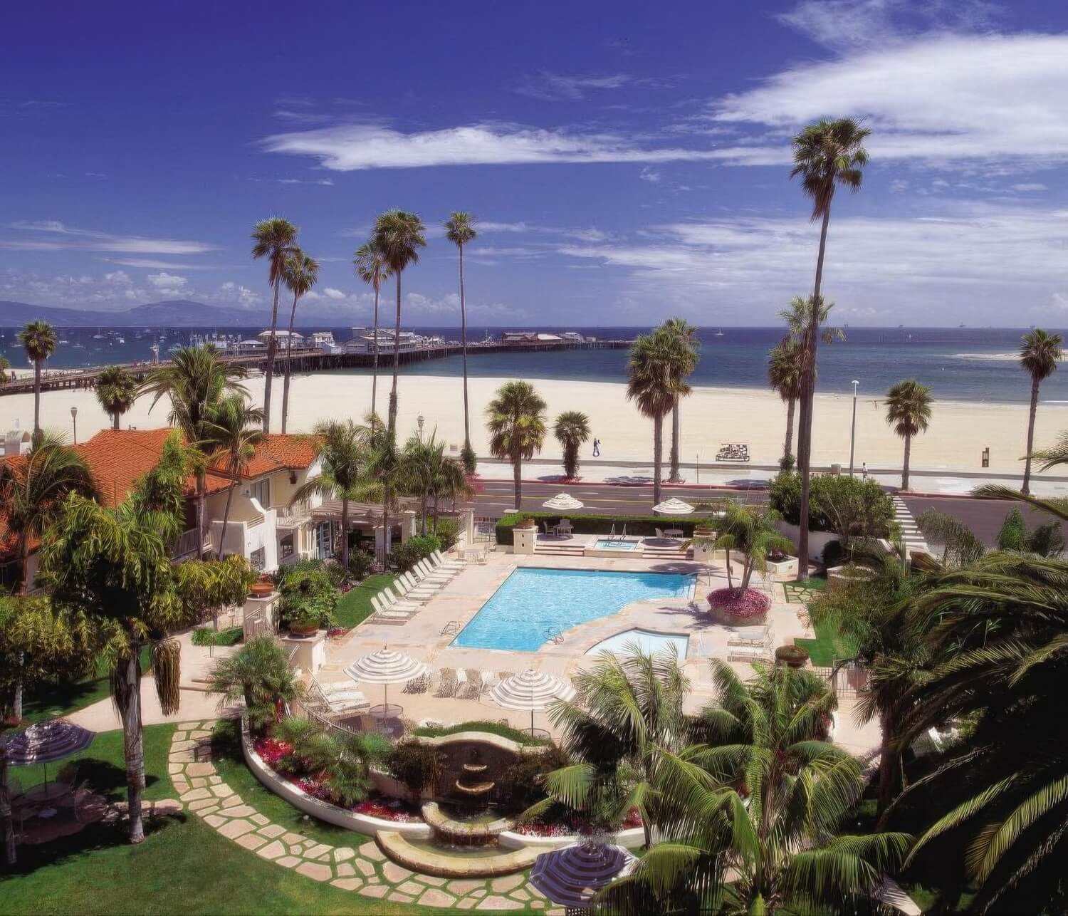 View over the pool and gardens to West Beach and Stearns Wharf at Harbor View Inn, Santa Barbara.