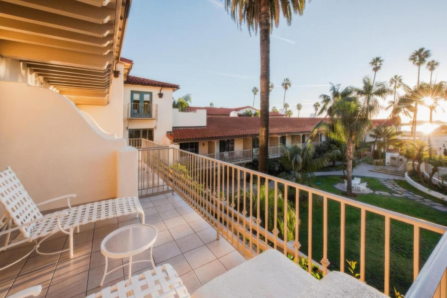 Private balcony with sun loungers above the courtyard gardens at Harbor View Inn, Santa Barbara.