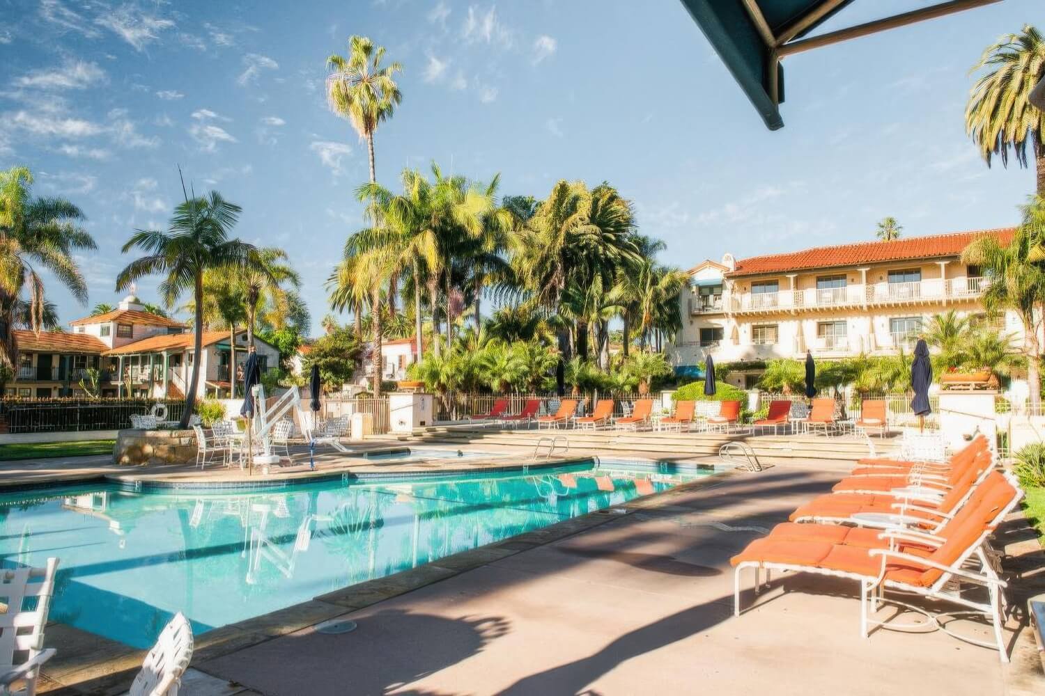 Pool and adjoining whirlpool framed by the red-tile roofline of Harbor View Inn, Santa Barbara.