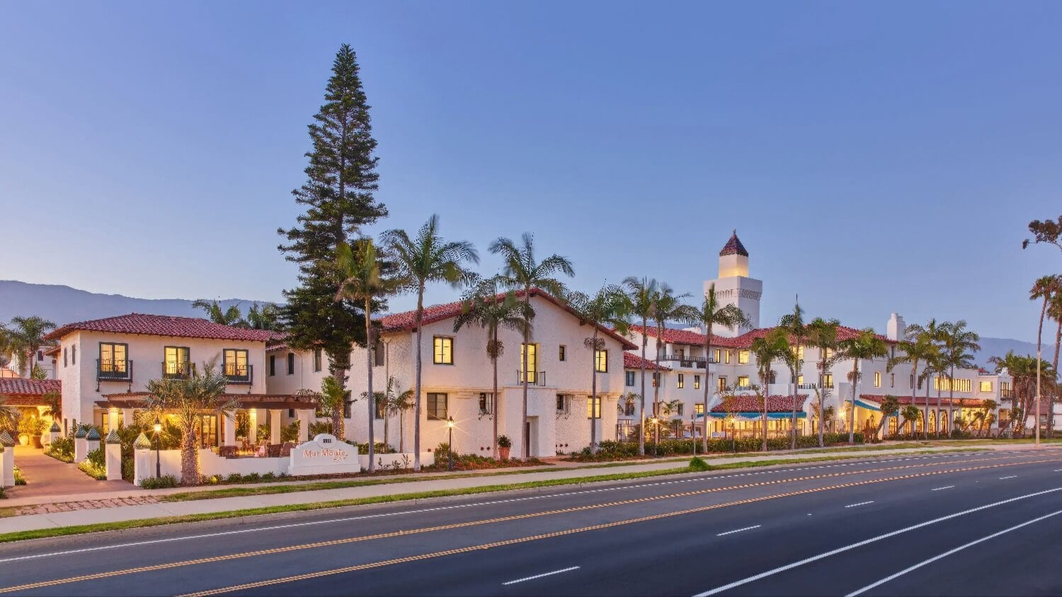 Spanish Colonial buildings and tower of Mar Monte Hotel at dusk along East Cabrillo Boulevard, Santa Barbara.
