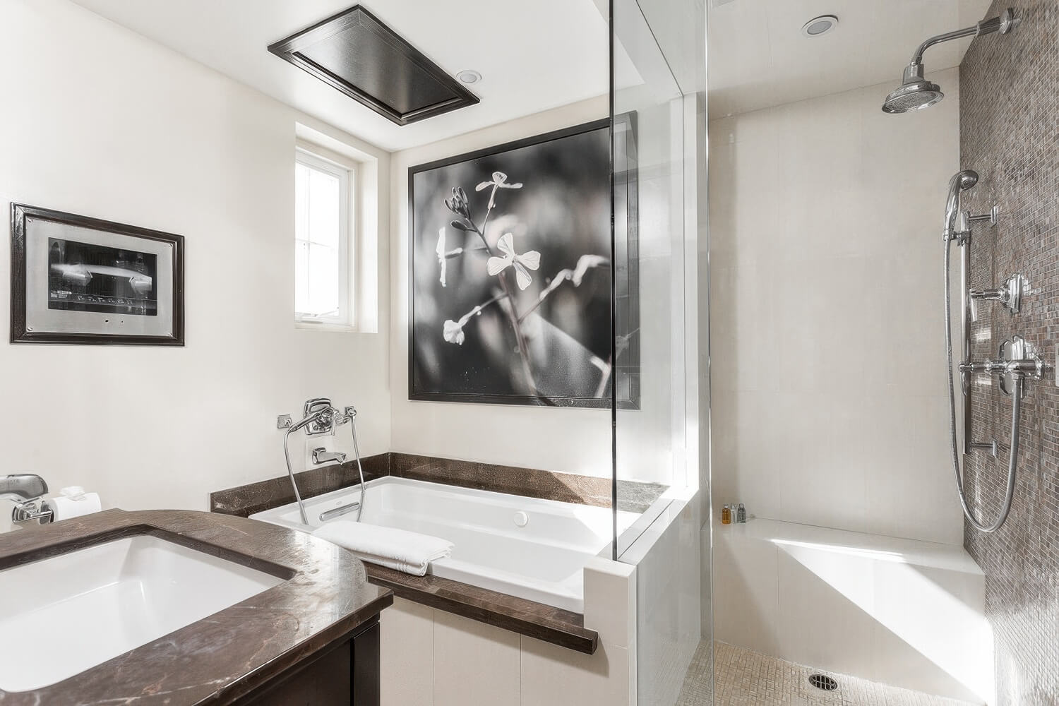 Bathroom with soaking tub and glass walk-in shower against a mosaic accent wall at the Montecito Inn, Montecito