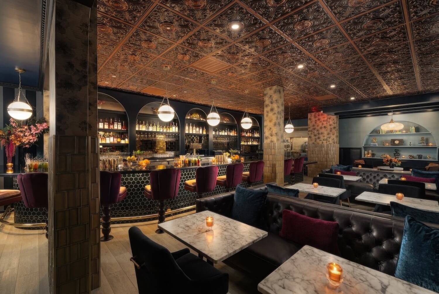 Lion's Tale cocktail bar with pressed-copper ceiling, curved honeycomb-tile bar and burgundy velvet stools at the Montecito Inn, Montecito