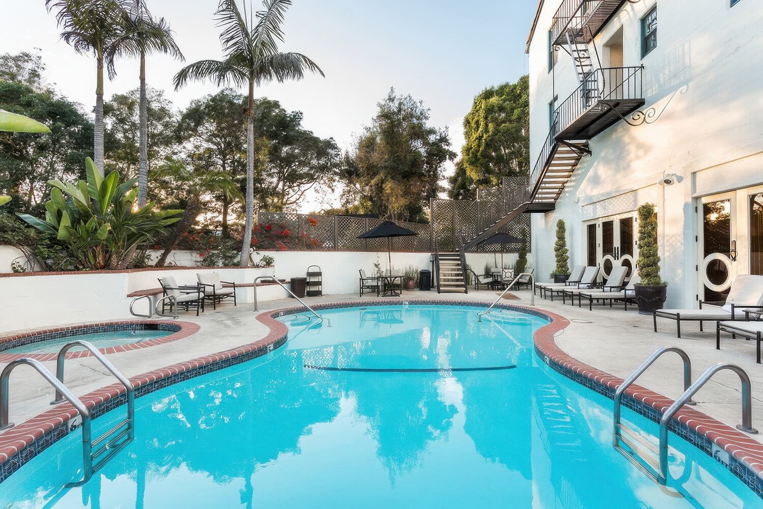 Heated outdoor pool and adjacent round hot tub in the walled courtyard of the Montecito Inn, Montecito