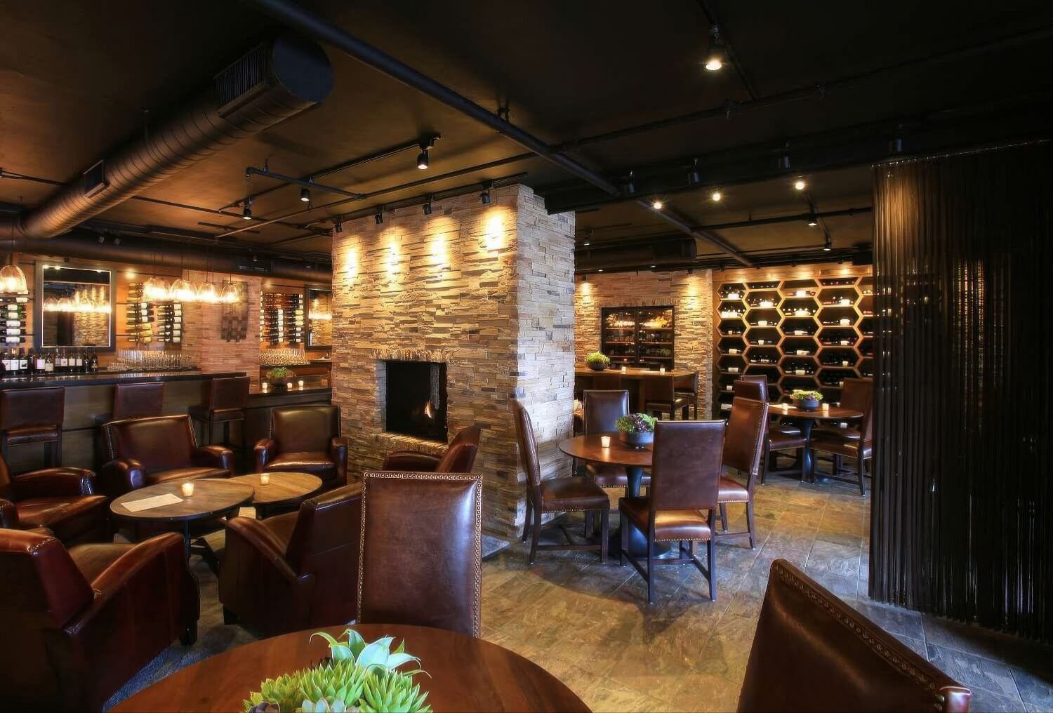 Stone fireplace and honeycomb wine racks in Stave Wine Cellar at The Inn at Spanish Bay, Pebble Beach